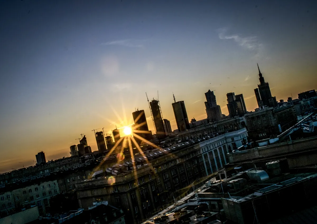 Sunstar over the Warsaw skyline with the Palace of Culture and Science in silhouette